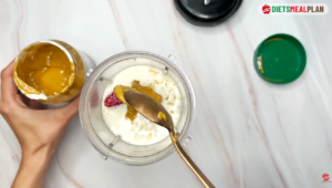 Place the bananas, strawberries, oats, raw almonds, peanut butter, and milk in a blender