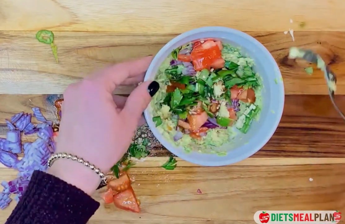 Vegan Mexican Burrito Recipe - Add the chopped onion, parsley, and jalapeño to the avocado. Squeeze in the juice of 1 lime