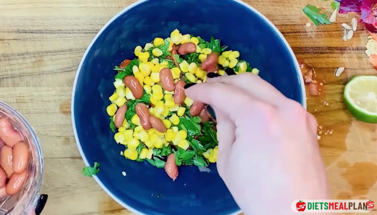 Vegan Mexican Burrito Recipe - Add the cooked corn, diced vegetables, and beans to a deep bowl