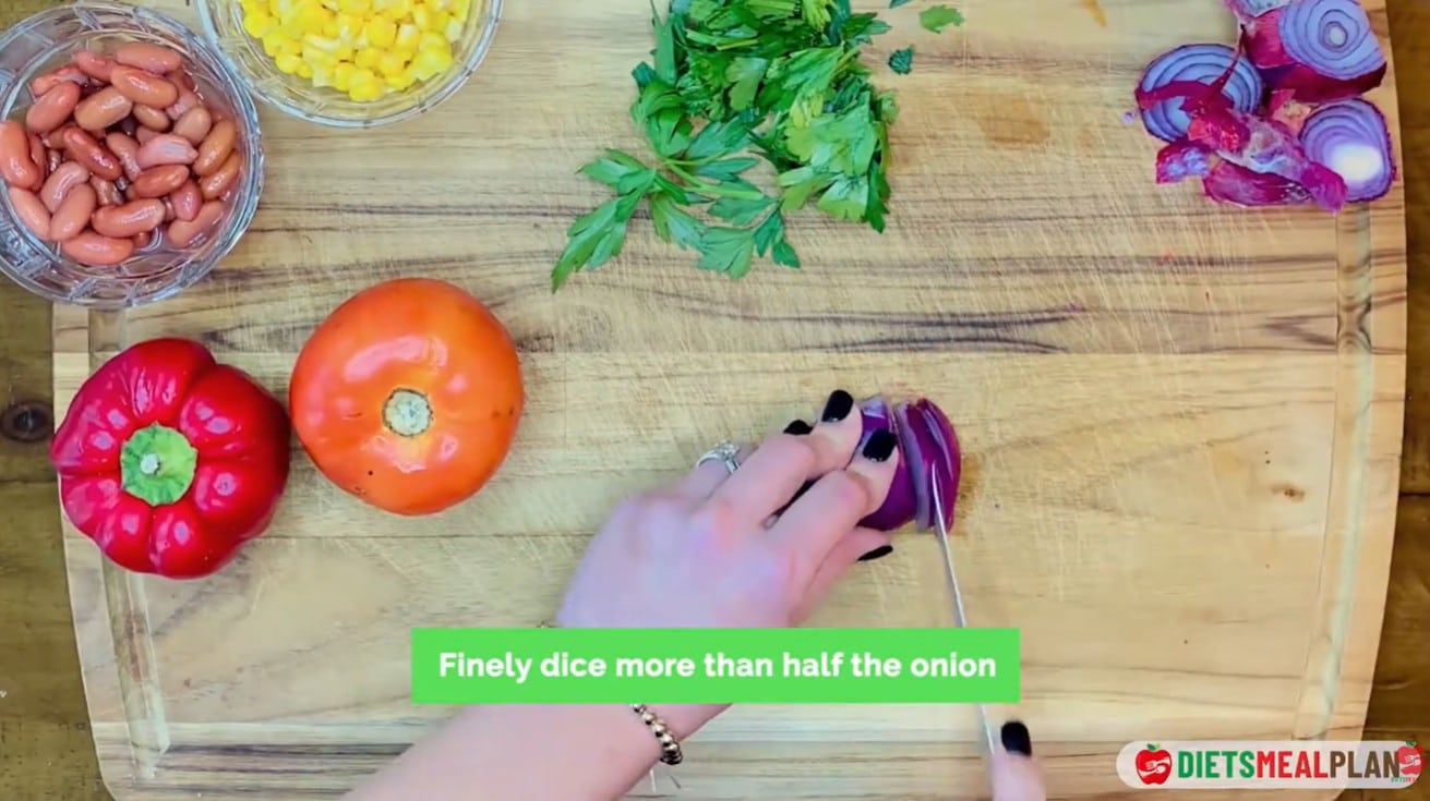 Vegan Mexican Burrito Recipe - Finely dice half a red onion, one red bell pepper, and one tomato
