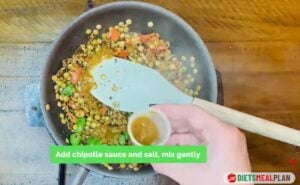 Vegan Mexican Burrito Recipe - Pour in the chipotle sauce, season with salt, and mix gently